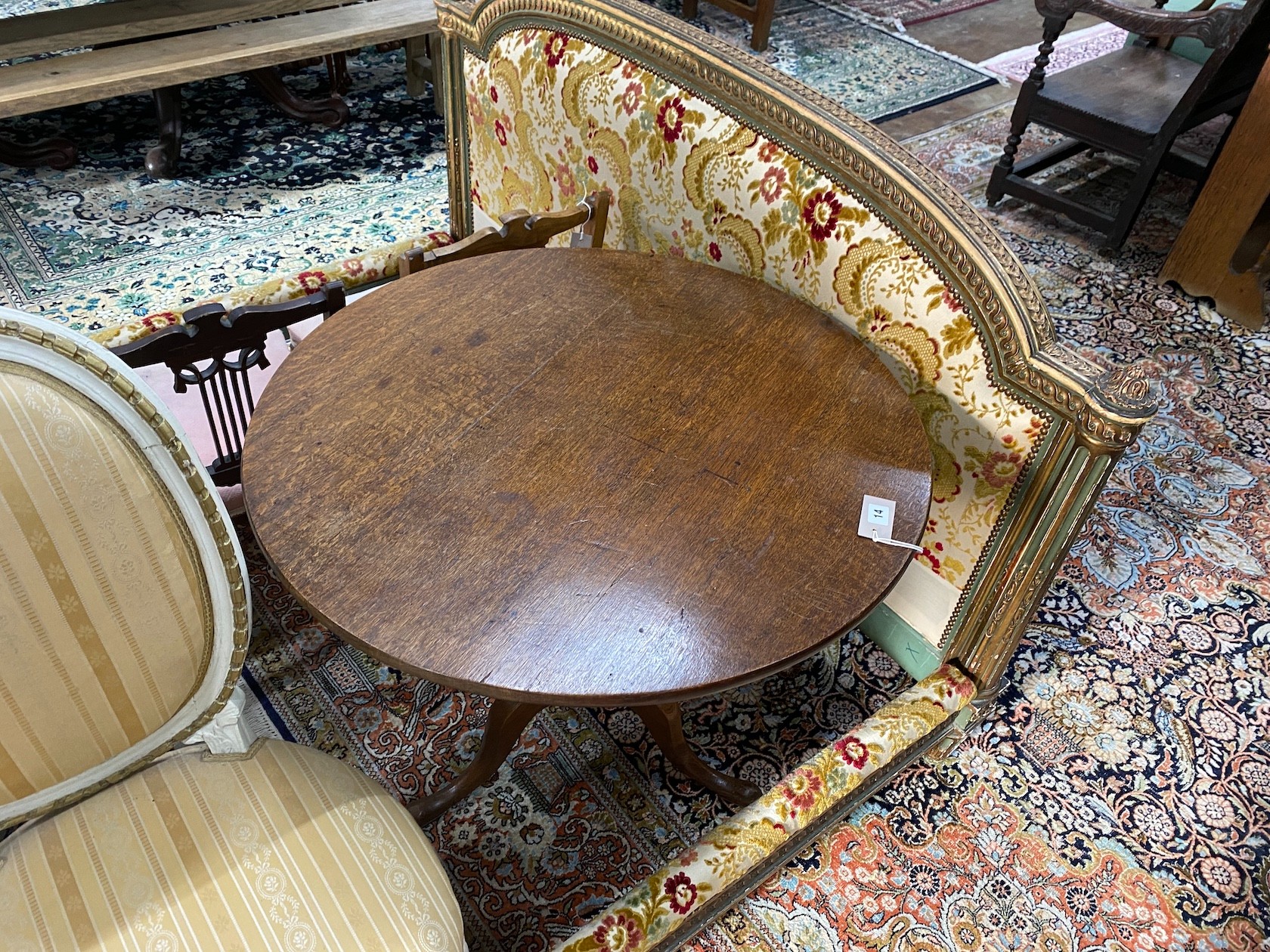 A George III oak circular tilt top tea table, diameter 82cm, height 72cm